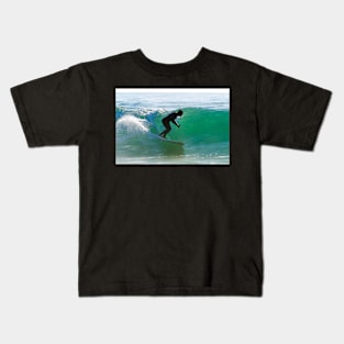 Long boarder surfing the waves at sunset Kids T-Shirt